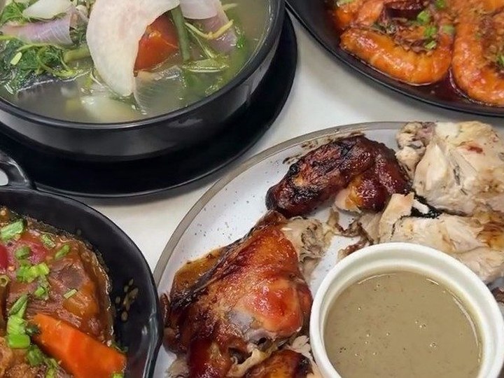 Table spread with grilled chicken, prawns and soup