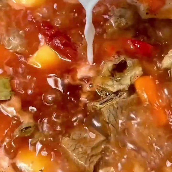 Beef kaldereta simmering with potato, carrot and bay leaf in a tomato sauce at Pinoy Tambayan