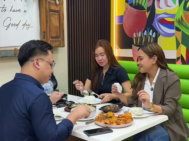 Guests at the table under the tambayan mural