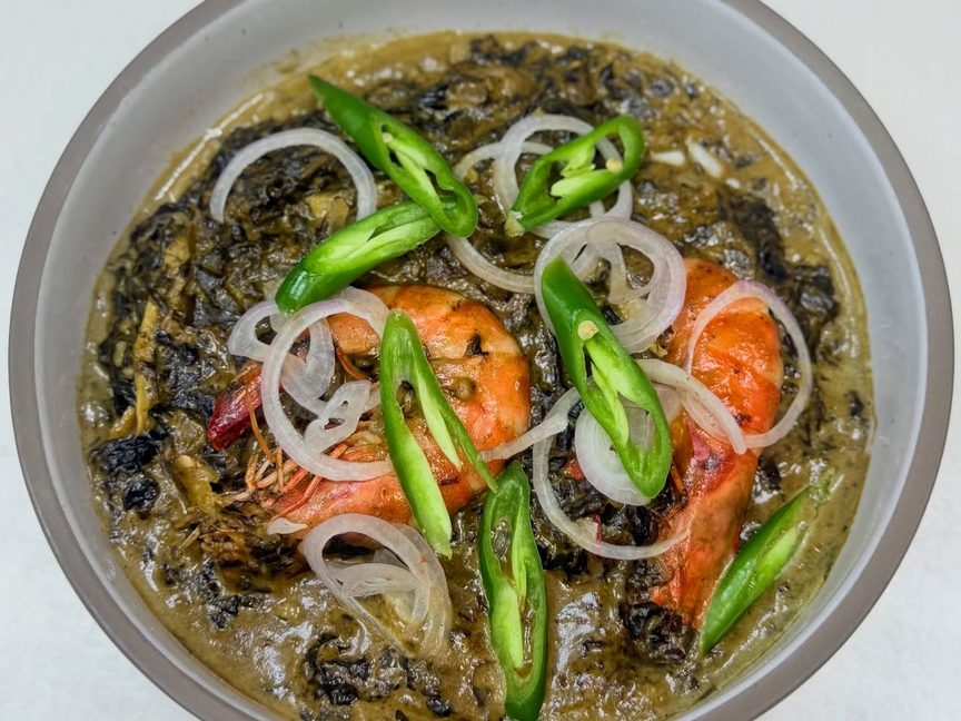 Laing: taro leaves in coconut cream topped with prawns