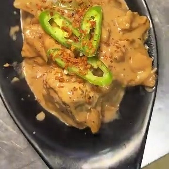 Chicken adobo sa gata in a creamy coconut sauce topped with green chillies at Pinoy Tambayan